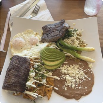 Carne asada with chilaquiles and refried beans